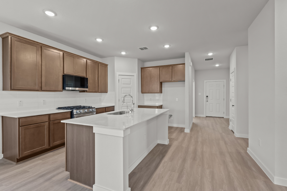 A kitchen with wooden cabinets.