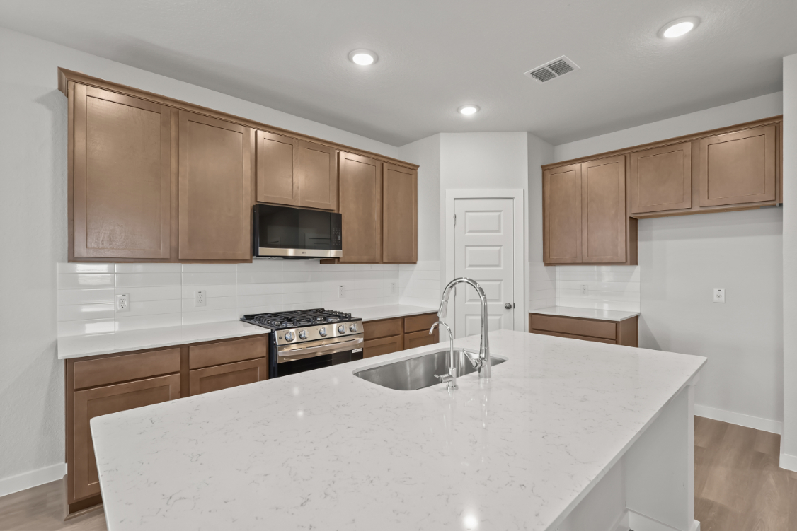 A kitchen with wooden cabinets.