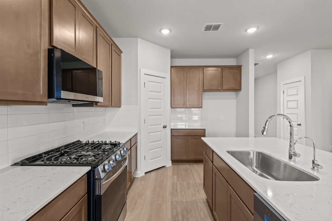 A kitchen with wooden cabinets.
