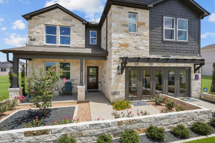 A house with a stone driveway.