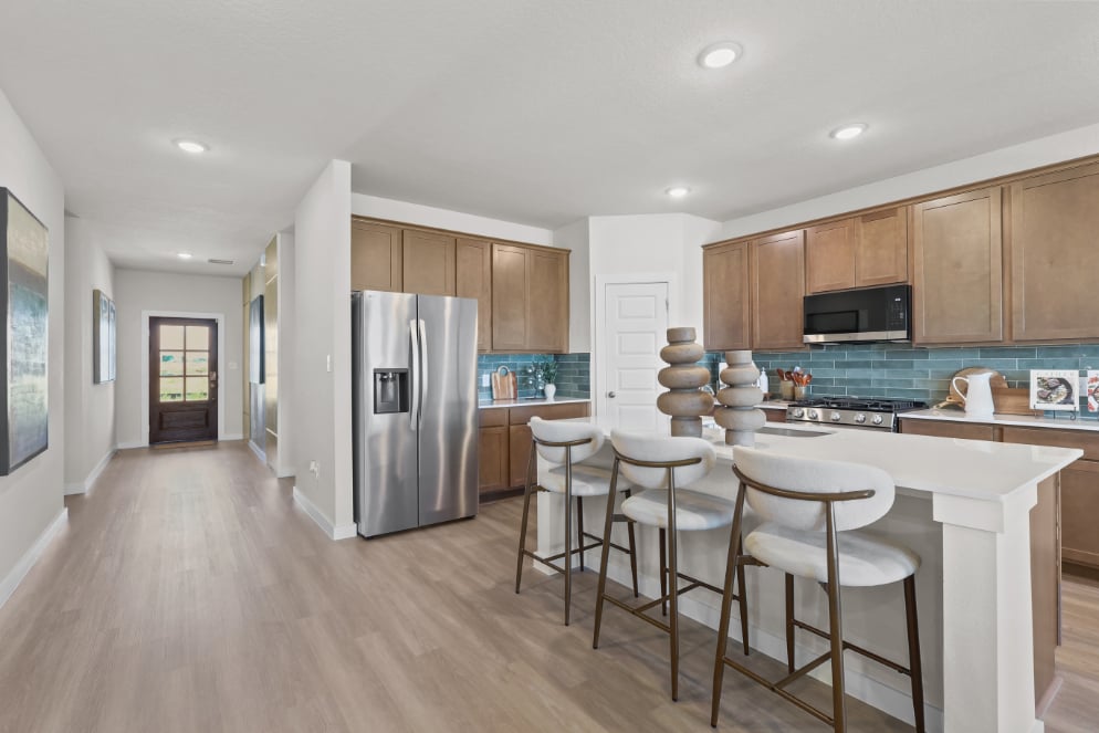 A kitchen with a wood floor.