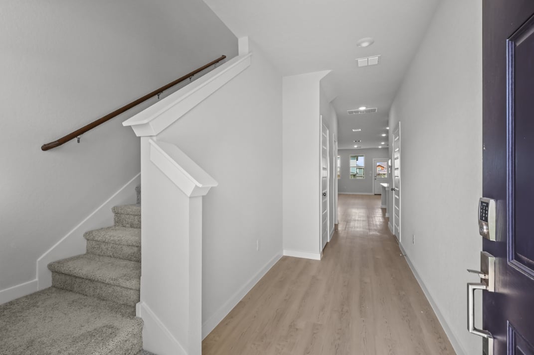 A long hallway with white walls.