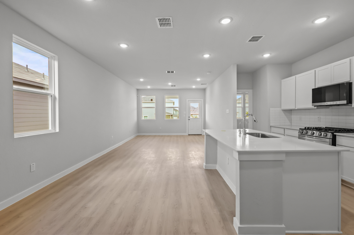 A kitchen with white cabinets.