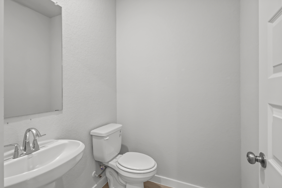 A bathroom with a toilet and sink.
