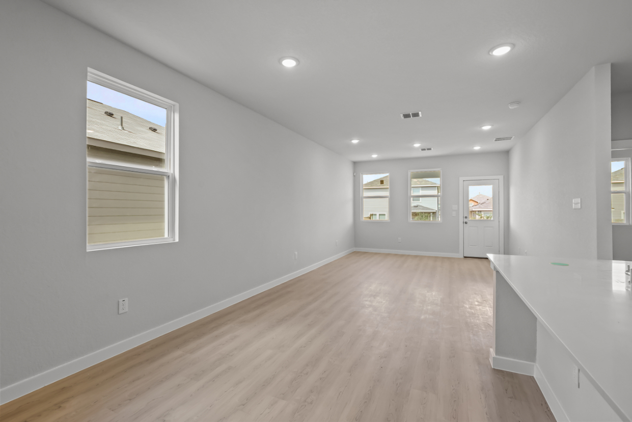A room with white walls and a wood floor.