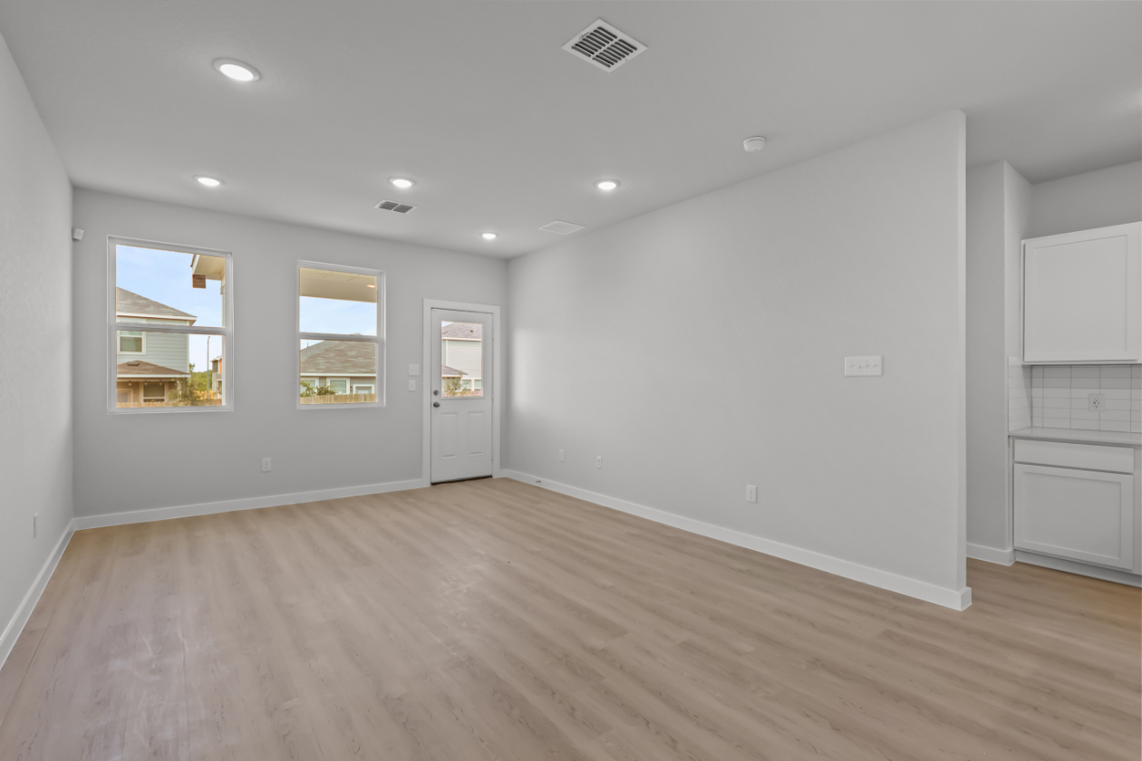 A room with white walls and a wood floor.