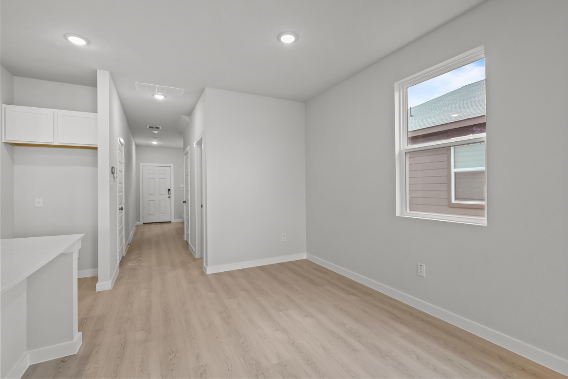 A room with white walls and a wood floor.