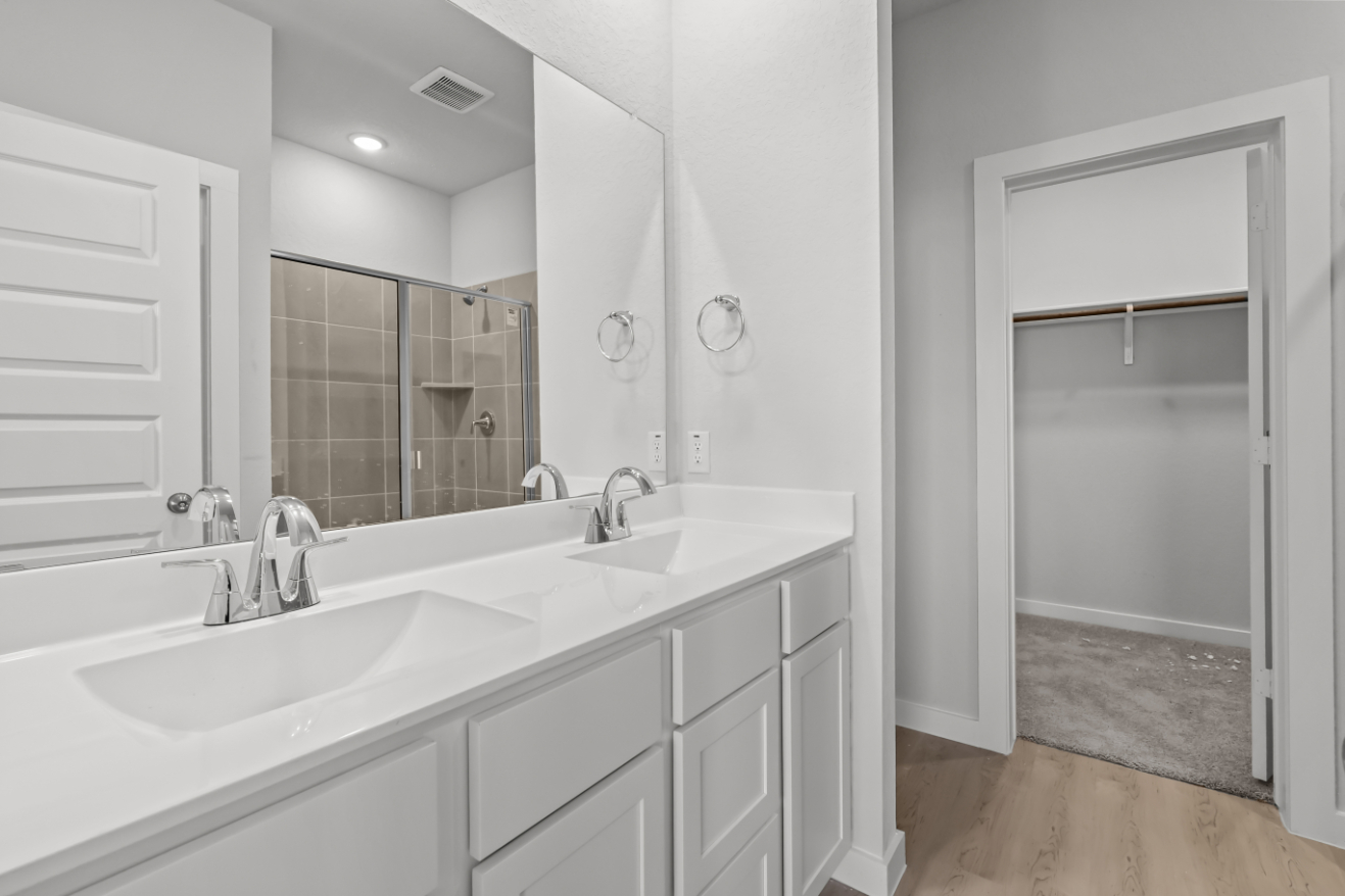 A bathroom with a large mirror.