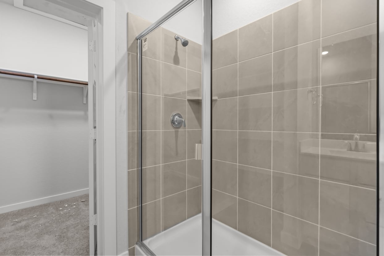 A shower with a glass door.