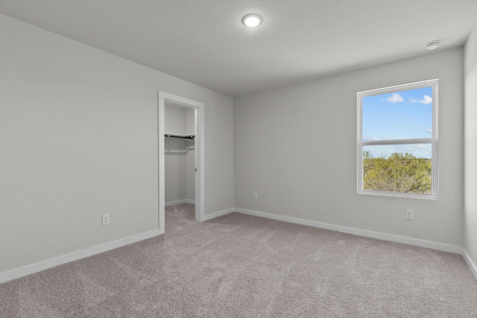 A room with a window and a shelf with a window.