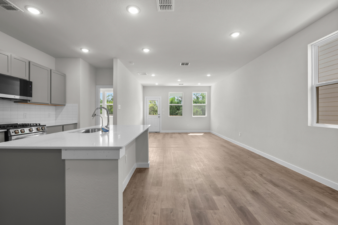 A kitchen with white cabinets.