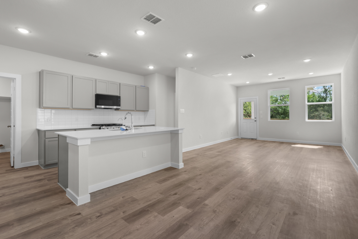 A kitchen with white cabinets.
