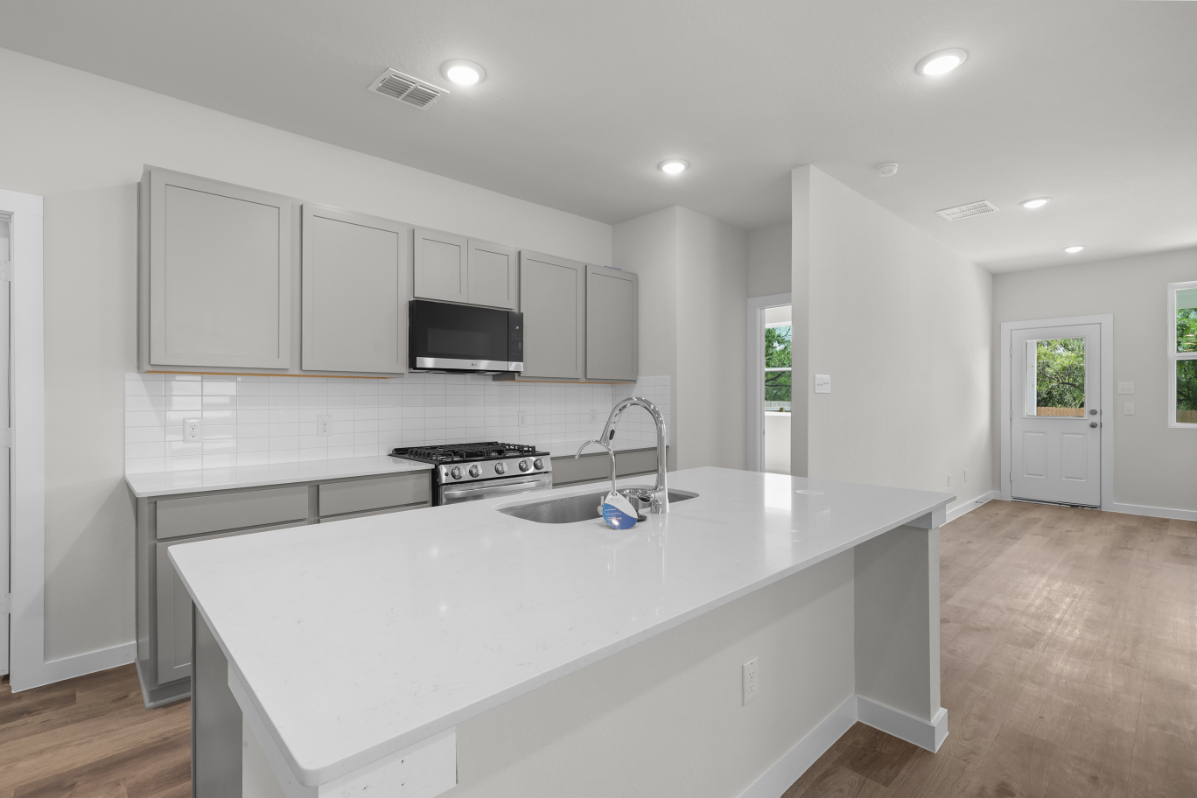 A kitchen with white cabinets.