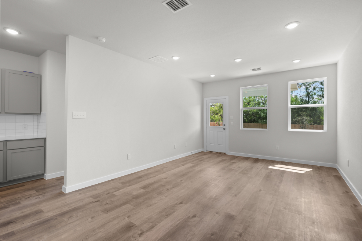 A room with a wood floor and white walls.