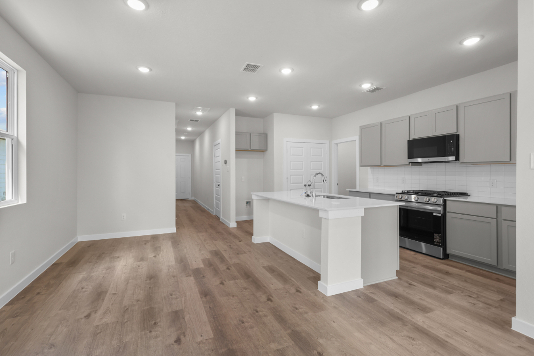 A kitchen with white cabinets.