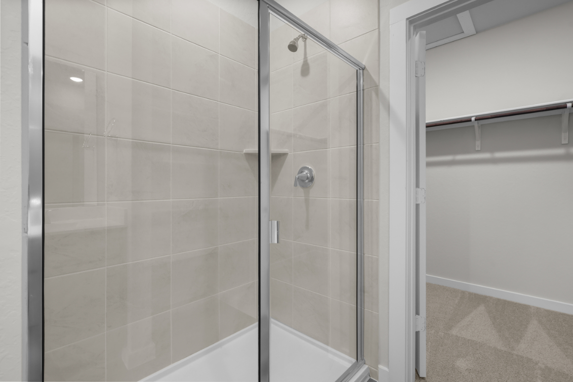 A shower with a glass door.