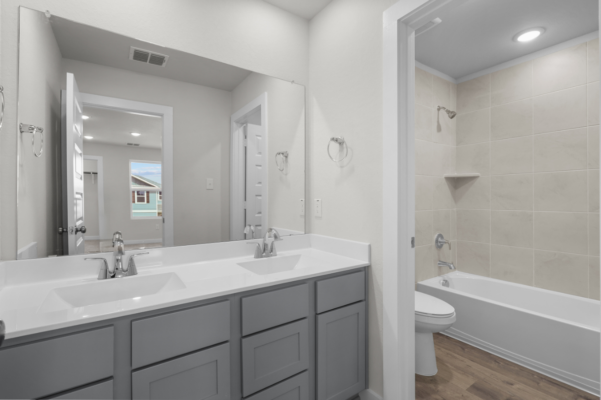 A bathroom with a tub sink and toilet.