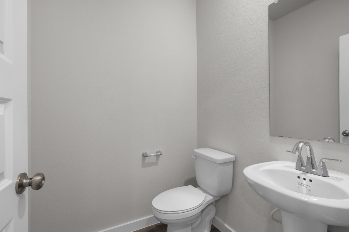 A bathroom with a toilet and sink.
