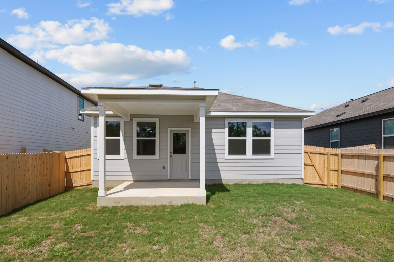 A house with a fence and grass.