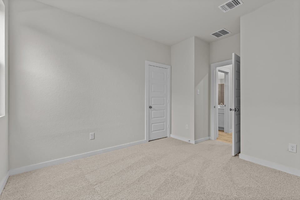 A hallway with white doors.