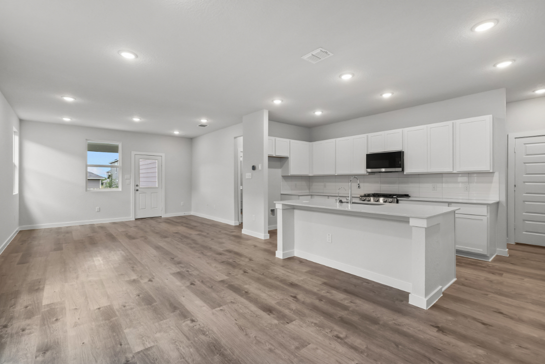 A kitchen with white cabinets.