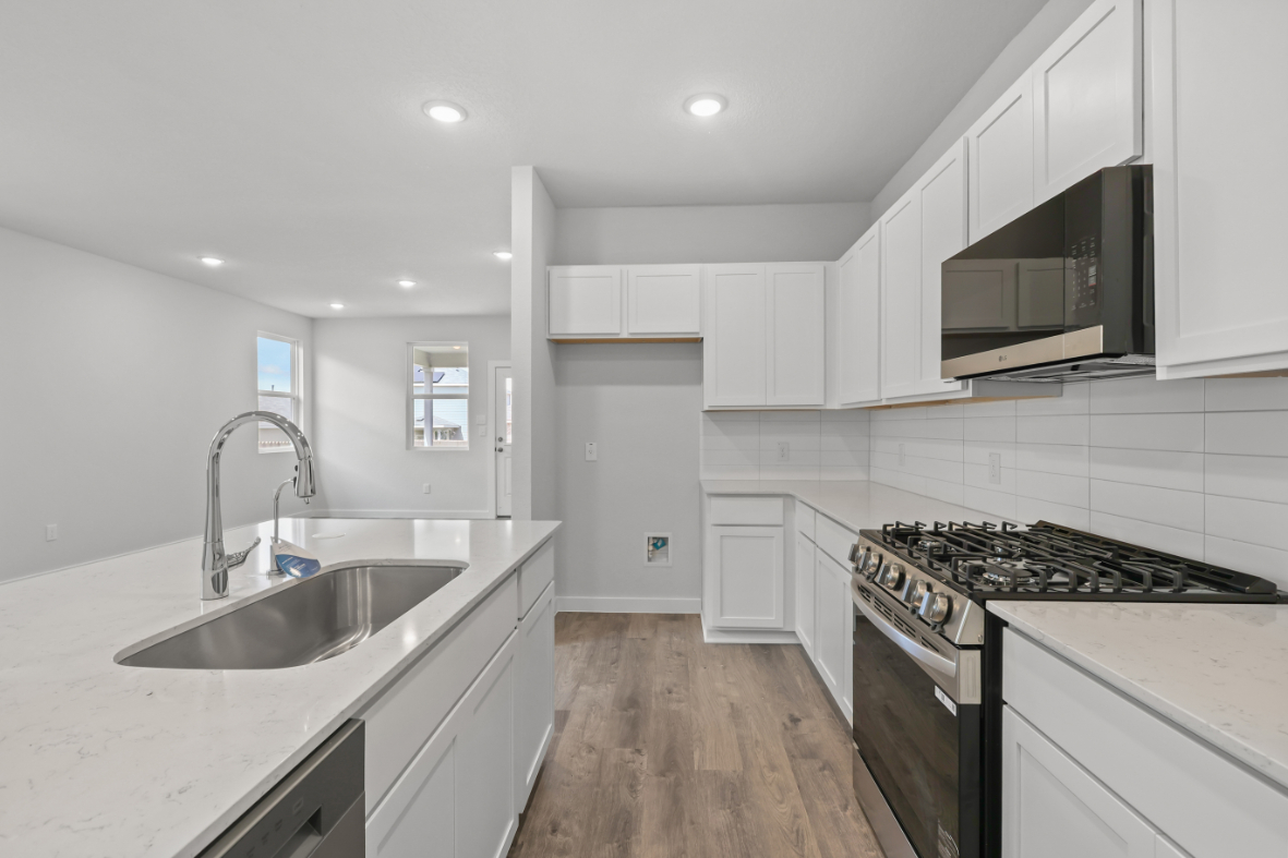 A kitchen with white cabinets.