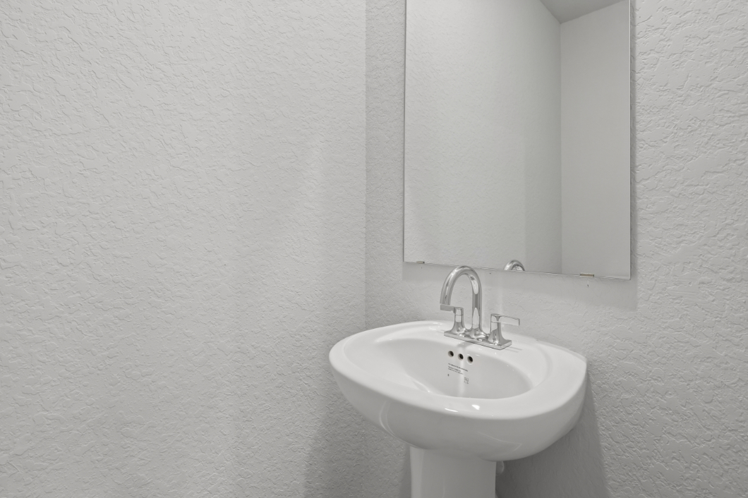A white sink in a bathroom.