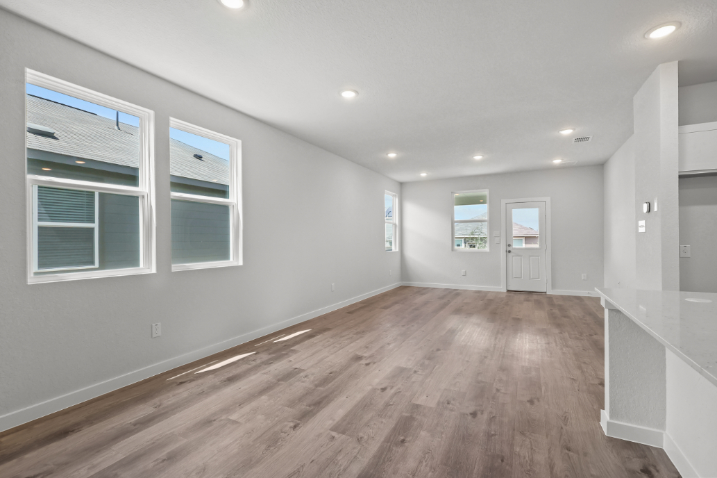 A room with a wood floor and white walls.