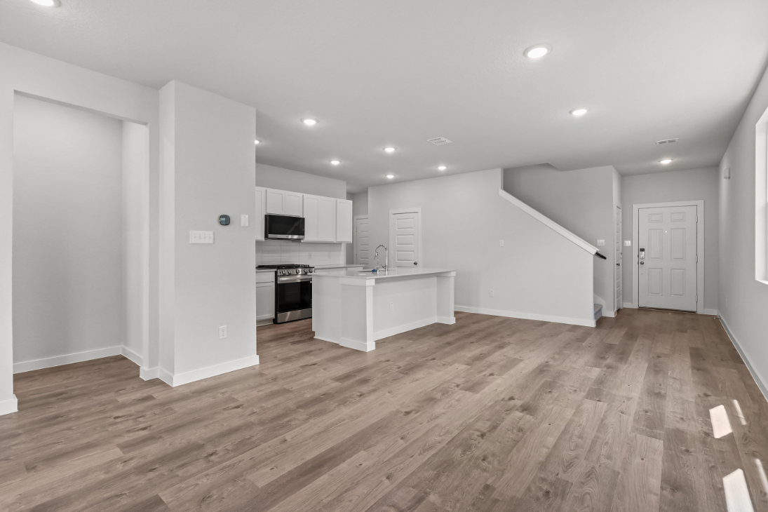 A large kitchen with white walls.
