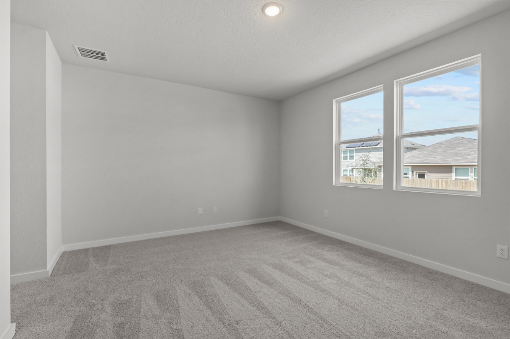 A room with a window and a wood floor.