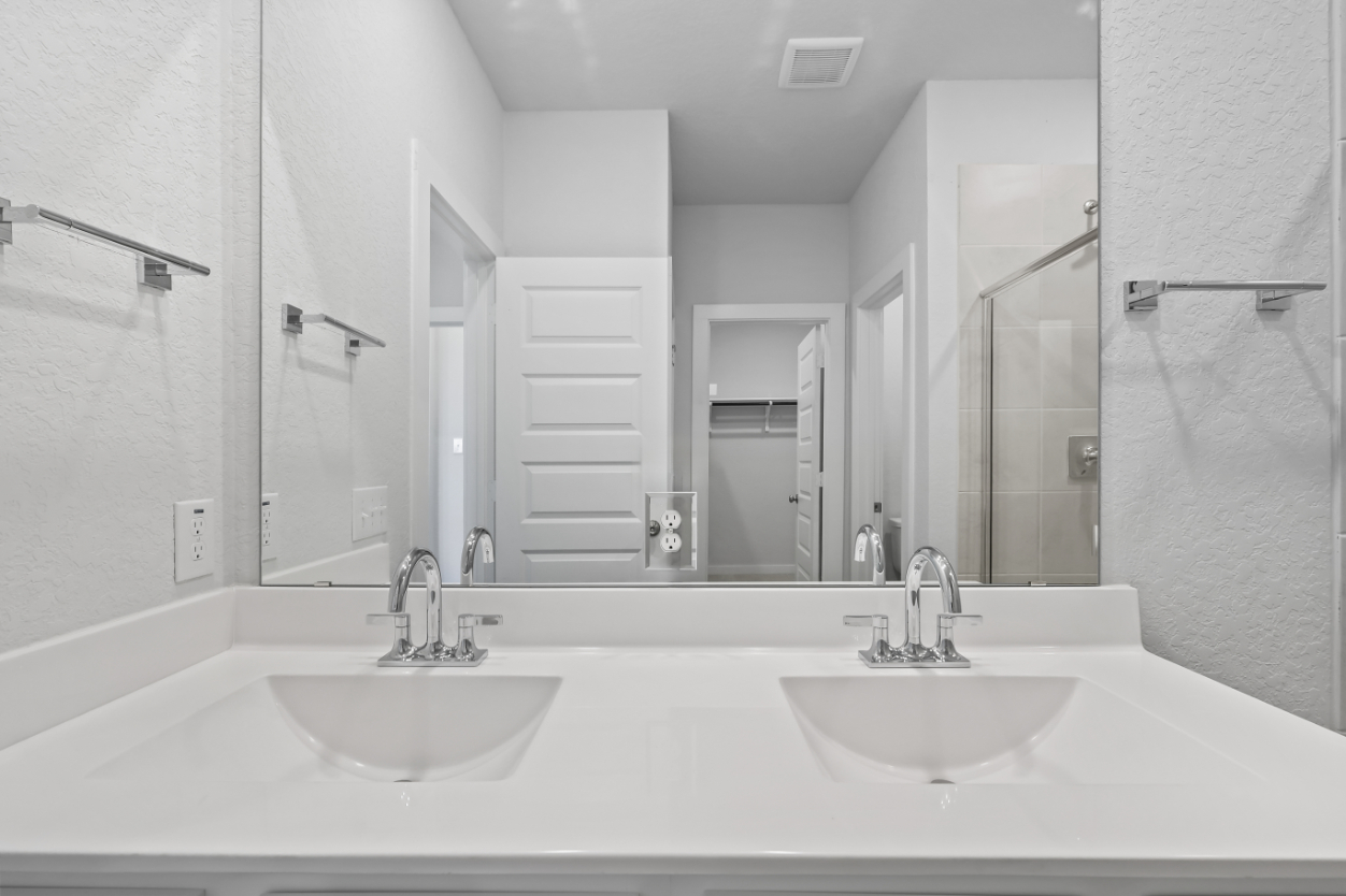 A bathroom with a large mirror.