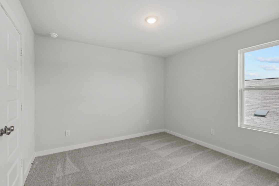 A room with a window and a door.