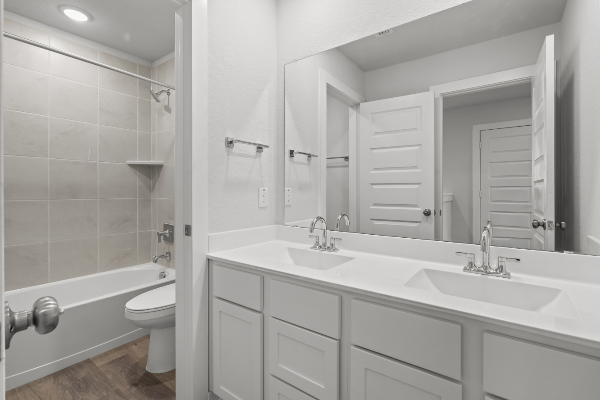 A bathroom with a sink toilet and bathtub.