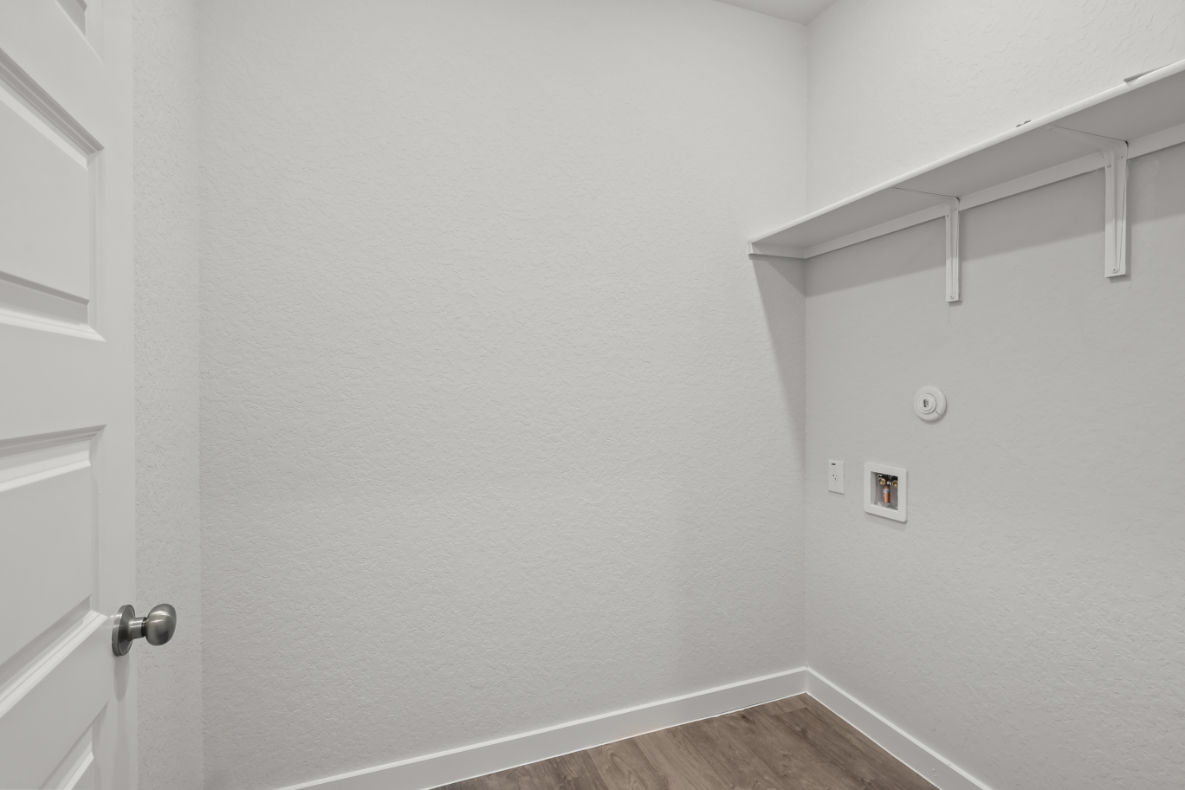 A white wall with a metal railing.