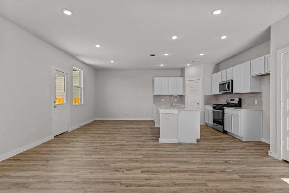A kitchen with white cabinets.