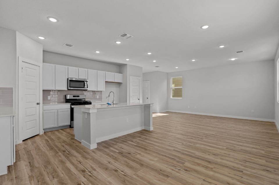 A kitchen with white cabinets.