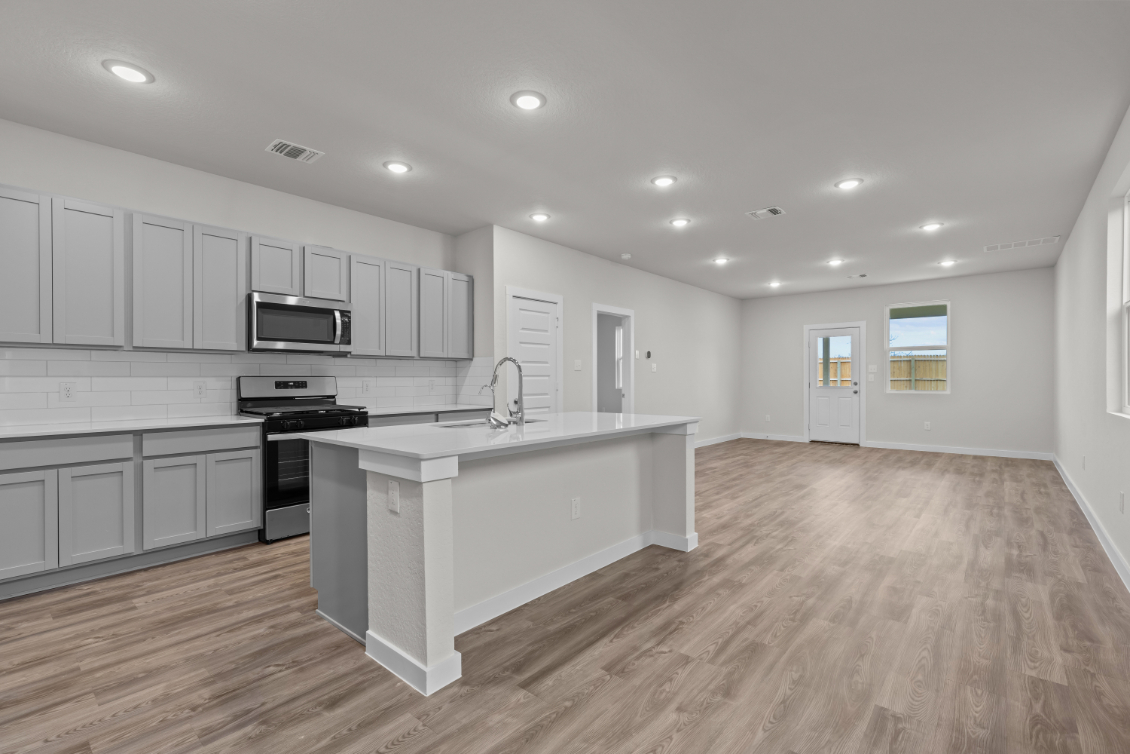 A kitchen with white cabinets.