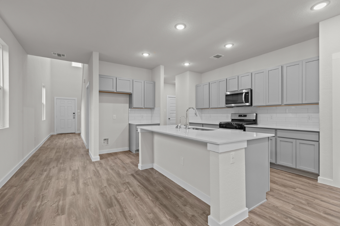 A kitchen with white cabinets.