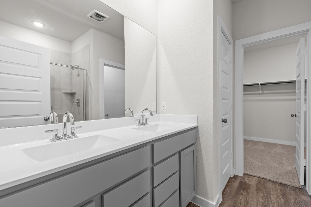 A bathroom with a large mirror.