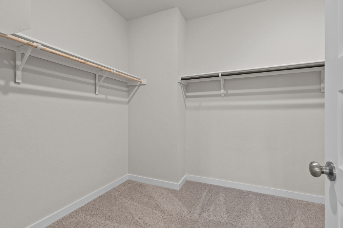 A white wall with a metal railing.