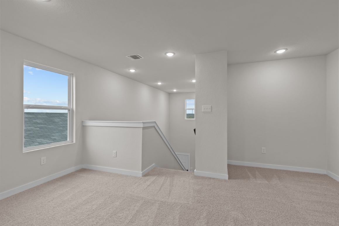 A room with a window and a staircase.