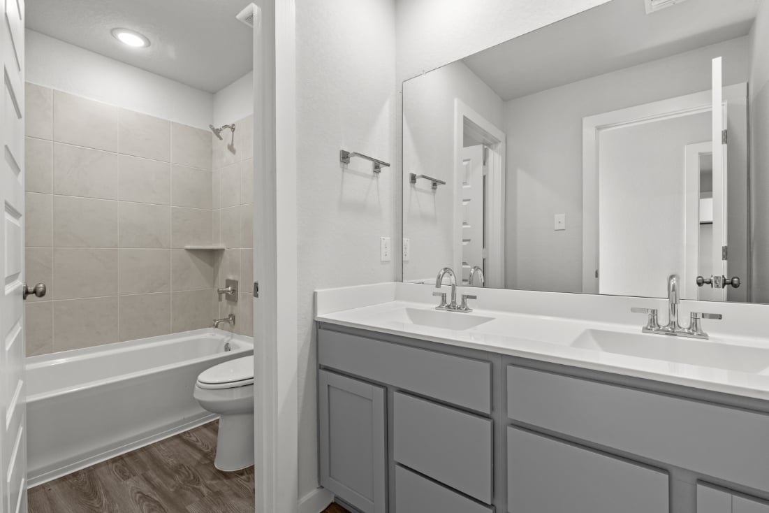 A bathroom with a tub sink and toilet.