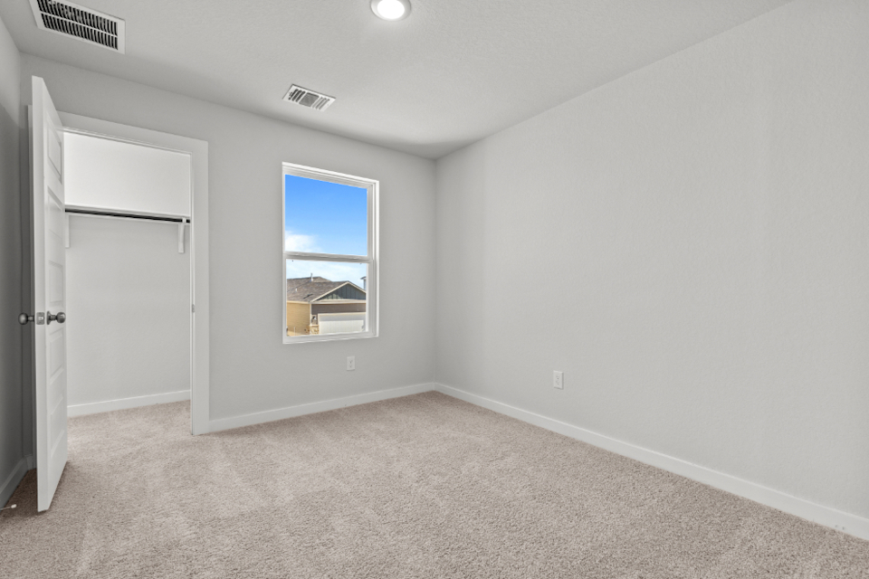 A room with a window and a door.