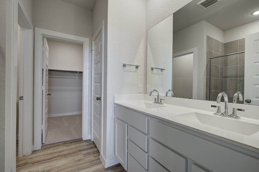 A bathroom with a large mirror.