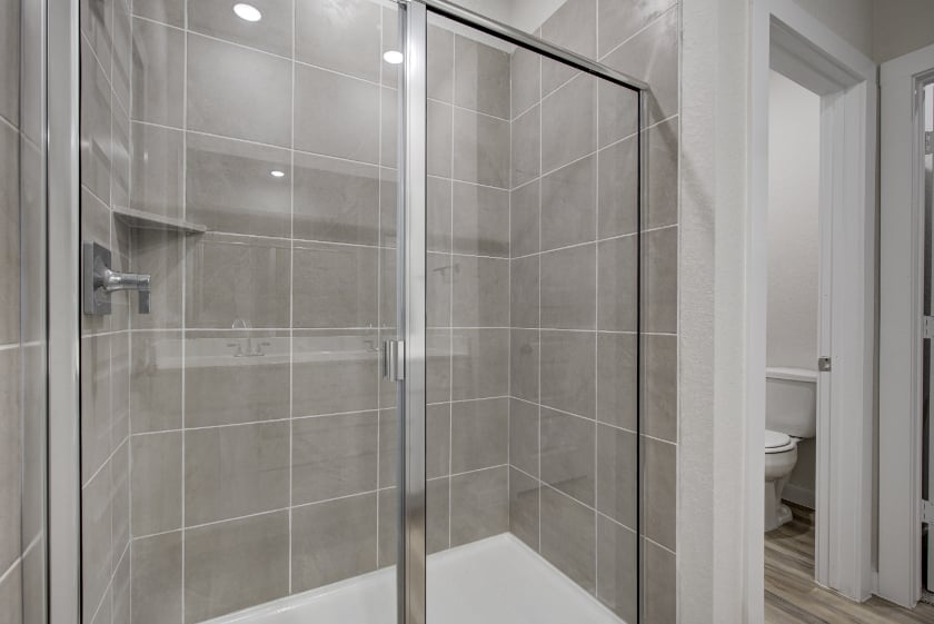 A shower with a glass door.