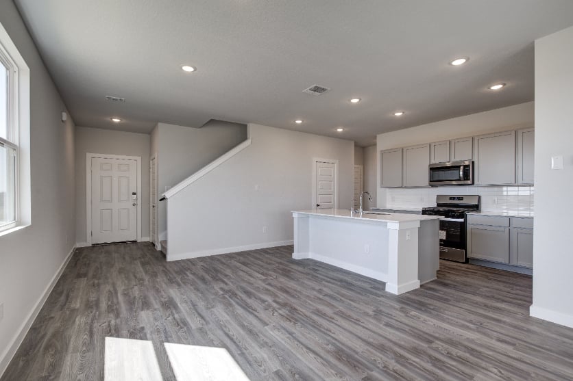 A kitchen with white cabinets.