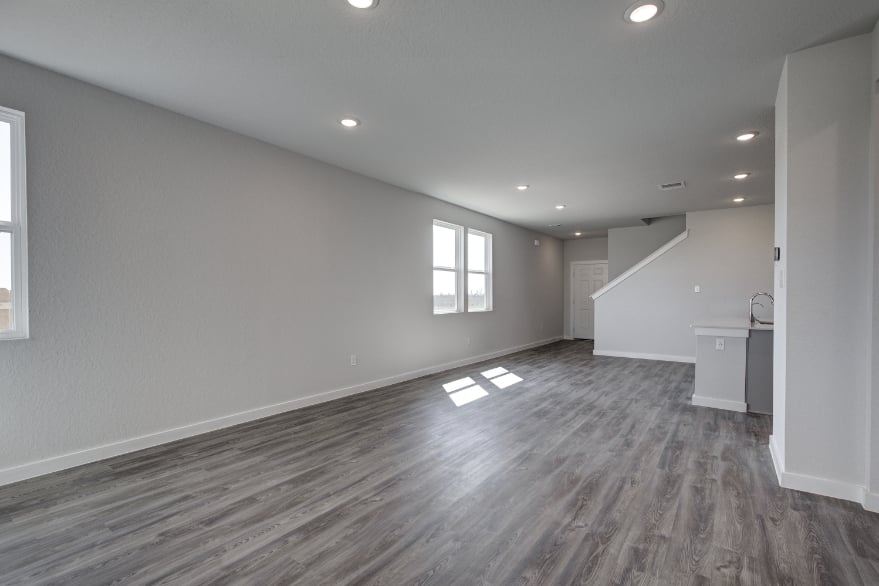 A room with a wood floor and windows.