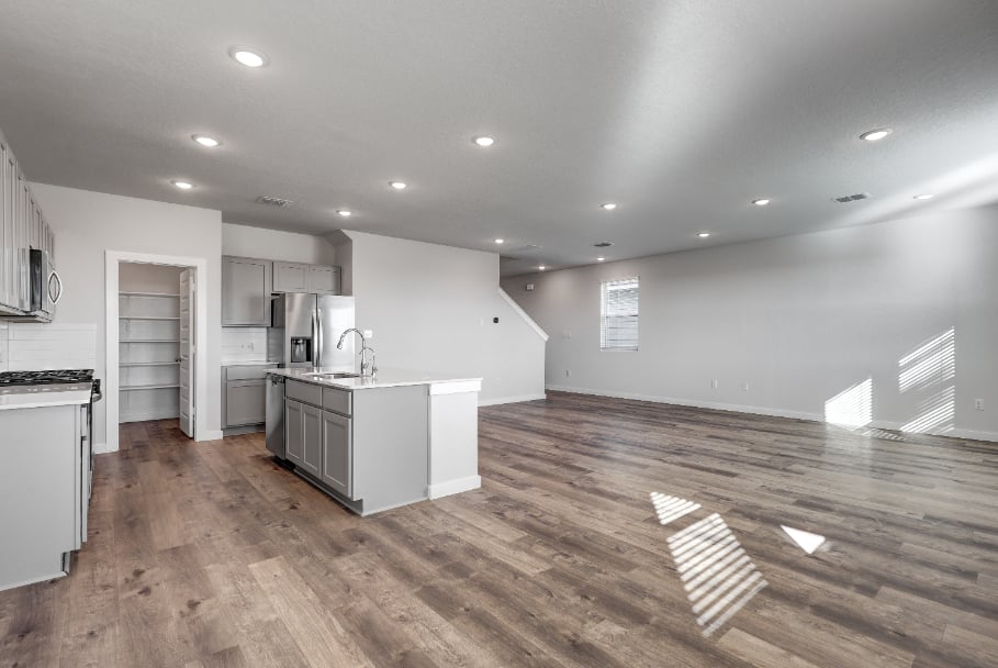 A kitchen with white cabinets.