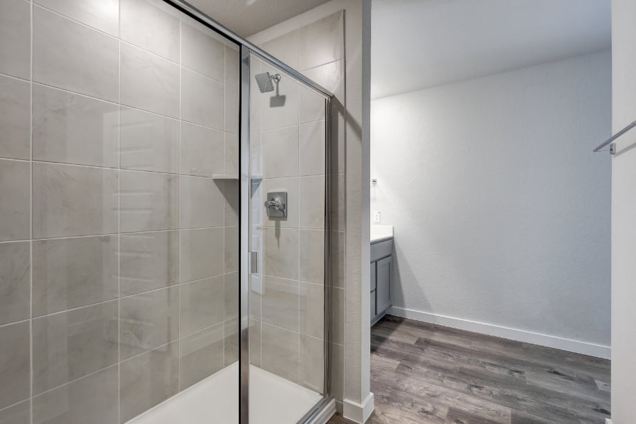 A shower with a glass door.