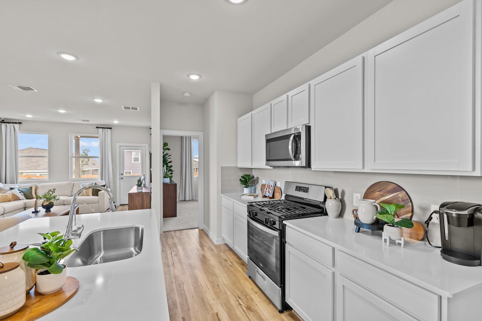 A kitchen with white cabinets.